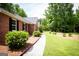 A home's brick exterior, showcasing a sidewalk and green shrubs at 155 Granby Ln, Fayetteville, GA 30215