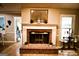 A fireplace with a classic design, brick hearth, decorative mantel, and views into other rooms at 155 Granby Ln, Fayetteville, GA 30215