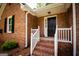 Close-up of the brick home's front entrance with steps leading to a black front door at 155 Granby Ln, Fayetteville, GA 30215