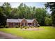Beautiful brick home with a lush green lawn and lovely garden beds at 155 Granby Ln, Fayetteville, GA 30215