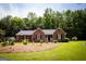 Charming home with a manicured front yard and mature trees at 155 Granby Ln, Fayetteville, GA 30215