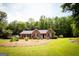 Charming brick home with a well-manicured lawn and complementary landscaping at 155 Granby Ln, Fayetteville, GA 30215