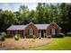 Well-maintained brick home with black shutters and a green front yard at 155 Granby Ln, Fayetteville, GA 30215
