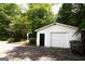 Single-car garage next to the house with black door and exterior storage at 155 Granby Ln, Fayetteville, GA 30215
