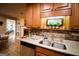 Close-up of a kitchen with granite countertops, wooden cabinets, stainless steel dishwasher, and brick backsplash at 155 Granby Ln, Fayetteville, GA 30215