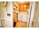Laundry room with wooden cabinets, white washer and dryer, shelving for storage at 155 Granby Ln, Fayetteville, GA 30215