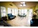Sunroom with glass table, blue chairs, vaulted ceiling, skylights, and lots of natural light at 155 Granby Ln, Fayetteville, GA 30215