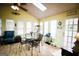 Bright sunroom featuring vaulted ceilings, skylights, and a glass table with black metal chairs at 155 Granby Ln, Fayetteville, GA 30215
