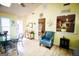 Bright sunroom featuring vaulted ceilings, skylights, a glass table with black metal chairs, and blue chair at 155 Granby Ln, Fayetteville, GA 30215