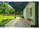 Covered porch overlooking fenced yard with mature trees at 120 Lakeside Dr, Ellenwood, GA 30294