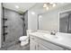 Modern bathroom featuring sleek gray tiled shower, pebble floor, and updated vanity at 120 Lakeside Dr, Ellenwood, GA 30294