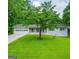 Charming single-story home featuring a well-maintained lawn and a classic white exterior at 120 Lakeside Dr, Ellenwood, GA 30294