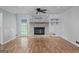 Open-concept living room highlighting hardwood floors, a stone fireplace, and modern lighting at 120 Lakeside Dr, Ellenwood, GA 30294