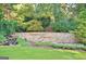 Beautiful stone community entrance with waterfall, landscaping, and Smokewise Plantation sign at 100 Smokerise Trce, Peachtree City, GA 30269