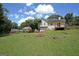 Spacious backyard featuring a fire pit, grassy area, and partial view of the home and detached garage at 634 Skyline Dr, Villa Rica, GA 30180