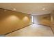 Unfinished basement area with tan walls, drop ceiling, and small window, ready for customization at 634 Skyline Dr, Villa Rica, GA 30180