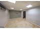 Unfinished basement area with gray walls, white ceiling tiles, and open doorway ready for customization at 634 Skyline Dr, Villa Rica, GA 30180