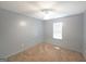 Neutral bedroom with beige carpeting, ceiling fan, and a large window at 634 Skyline Dr, Villa Rica, GA 30180