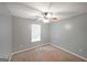 Neutral bedroom with beige carpeting, ceiling fan, and a large window at 634 Skyline Dr, Villa Rica, GA 30180