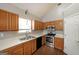 Well-lit kitchen with stainless steel appliances, wooden cabinets, and a view from the window at 634 Skyline Dr, Villa Rica, GA 30180