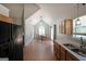 Open kitchen area with sink, wooden cabinets, and black appliances in view of the dining room at 634 Skyline Dr, Villa Rica, GA 30180