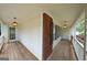 Inviting covered porch featuring wood flooring and decorative lighting fixtures at 634 Skyline Dr, Villa Rica, GA 30180