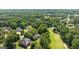 Aerial view showcasing homes and the golf course surrounded by green trees in the neighborhood at 595 Mcgarity Dr, Mcdonough, GA 30252