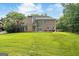 Expansive backyard featuring a well-maintained lawn and the rear view of a brick home at 595 Mcgarity Dr, Mcdonough, GA 30252