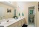 Well-lit bathroom featuring a double vanity, framed mirrors, and tile floors at 595 Mcgarity Dr, Mcdonough, GA 30252