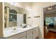 Bright bathroom with double vanity, large mirror, wood accents, and a connecting door to the main bedroom at 595 Mcgarity Dr, Mcdonough, GA 30252