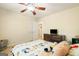 Bedroom with a full sized bed, dresser with a television, and ceiling fan at 595 Mcgarity Dr, Mcdonough, GA 30252