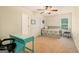 Bedroom features a desk, bed, ceiling fan, and natural light at 595 Mcgarity Dr, Mcdonough, GA 30252