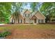 Inviting brick home with a welcoming front porch and neatly landscaped yard at 595 Mcgarity Dr, Mcdonough, GA 30252