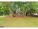 Two story brick house with manicured front lawn, showcasing mature landscaping and welcoming curb appeal at 595 Mcgarity Dr, Mcdonough, GA 30252