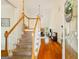Bright foyer with hardwood floors, staircase, and views into the living area at 595 Mcgarity Dr, Mcdonough, GA 30252