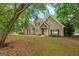 Charming brick home with well-manicured lawn and lush trees providing shade and privacy at 595 Mcgarity Dr, Mcdonough, GA 30252