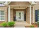 Charming front porch with brick accents and a decorative 'welcome' sign at 595 Mcgarity Dr, Mcdonough, GA 30252