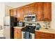 Bright kitchen with wood cabinets, stainless steel appliances, and a view of the countertop space at 595 Mcgarity Dr, Mcdonough, GA 30252