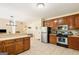 Well-lit kitchen with stainless steel appliances, tile flooring, wooden cabinets, and views to the dining area at 595 Mcgarity Dr, Mcdonough, GA 30252