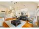 Spacious living room with a high ceiling, hardwood floors, a staircase, and a comfortable seating arrangement at 595 Mcgarity Dr, Mcdonough, GA 30252