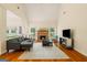 Spacious living room with a brick fireplace, hardwood floors, and ample natural light at 595 Mcgarity Dr, Mcdonough, GA 30252