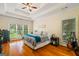 Serene main bedroom with tray ceilings, hardwood floors, and large windows providing ample natural light at 595 Mcgarity Dr, Mcdonough, GA 30252