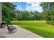Outdoor patio space with seating and a lush, sprawling lawn perfect for entertaining at 595 Mcgarity Dr, Mcdonough, GA 30252