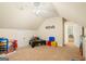 Spacious playroom with a sloped ceiling, ceiling fan, and plenty of room for activities at 595 Mcgarity Dr, Mcdonough, GA 30252