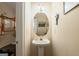 Charming powder room with a pedestal sink and decorative mirror at 595 Mcgarity Dr, Mcdonough, GA 30252