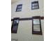 Detailed view of the home's exterior with dark brown trim and light brown stucco at 6266 Auburn Dr, Riverdale, GA 30296