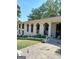 Side view of home with unique, arched porch openings and mature trees at 6266 Auburn Dr, Riverdale, GA 30296