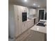 Modern kitchen boasts white cabinets, quartz countertops, and stainless steel appliances at 6266 Auburn Dr, Riverdale, GA 30296