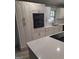 Kitchen with stainless steel appliances, white cabinetry, and quartz countertops at 6266 Auburn Dr, Riverdale, GA 30296
