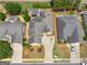 An aerial view of the property featuring a well-maintained lawn, driveway, and partial backyard view at 141 Wexford Ct, Stockbridge, GA 30281